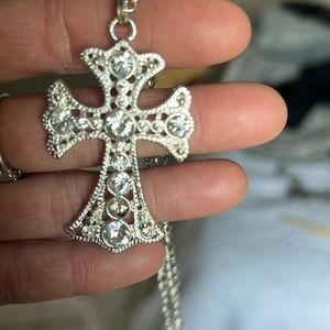 Silver color rhinestone cross on silver color chain.
